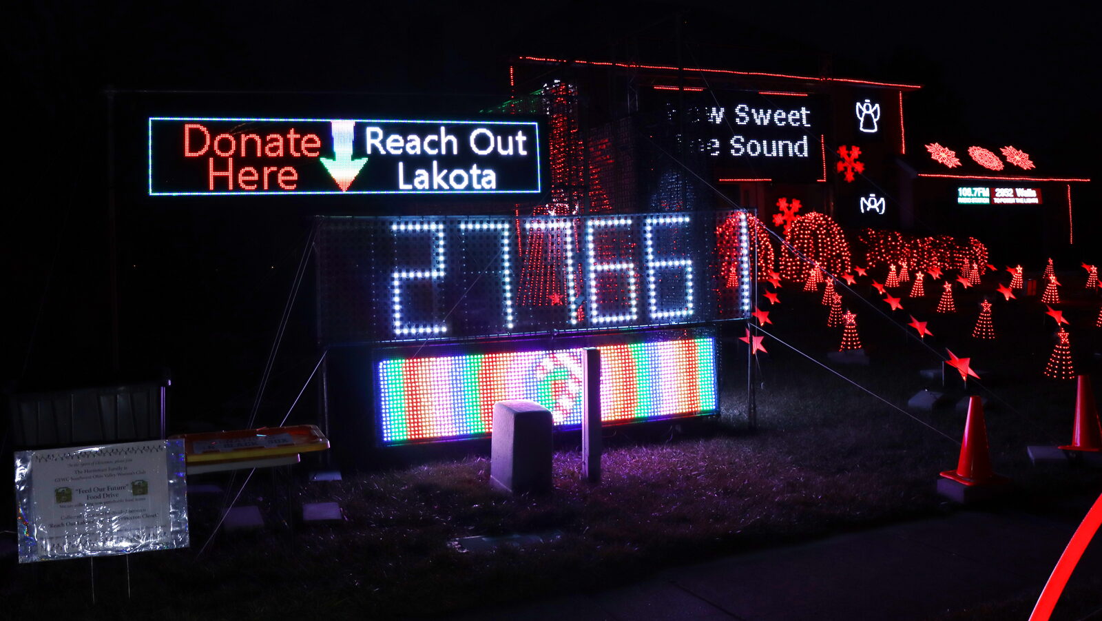 The Donate Here — Reach Out Lakota sign at night in 2023