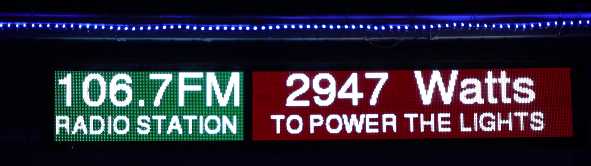 The information board at night showing 106.7FM Radio Station and 2947 Watts to power the lights