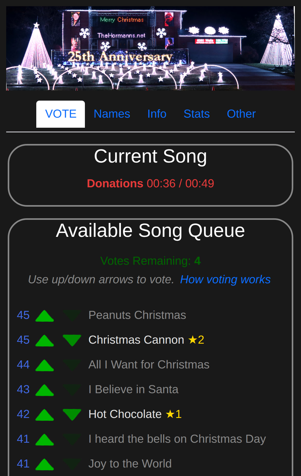 The vote-now.org voting page on a phone, showing the current song and the song queue with votes cast for Christmas Cannon and Hot Chocolate